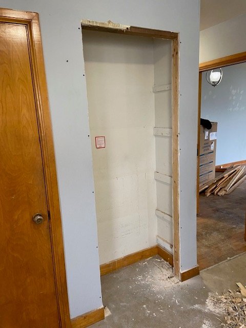 In the kitchen, facing south, there are two pantries. The right side one has had its moulding and door removed and enlarged to accommodate a 24 inch fridge.